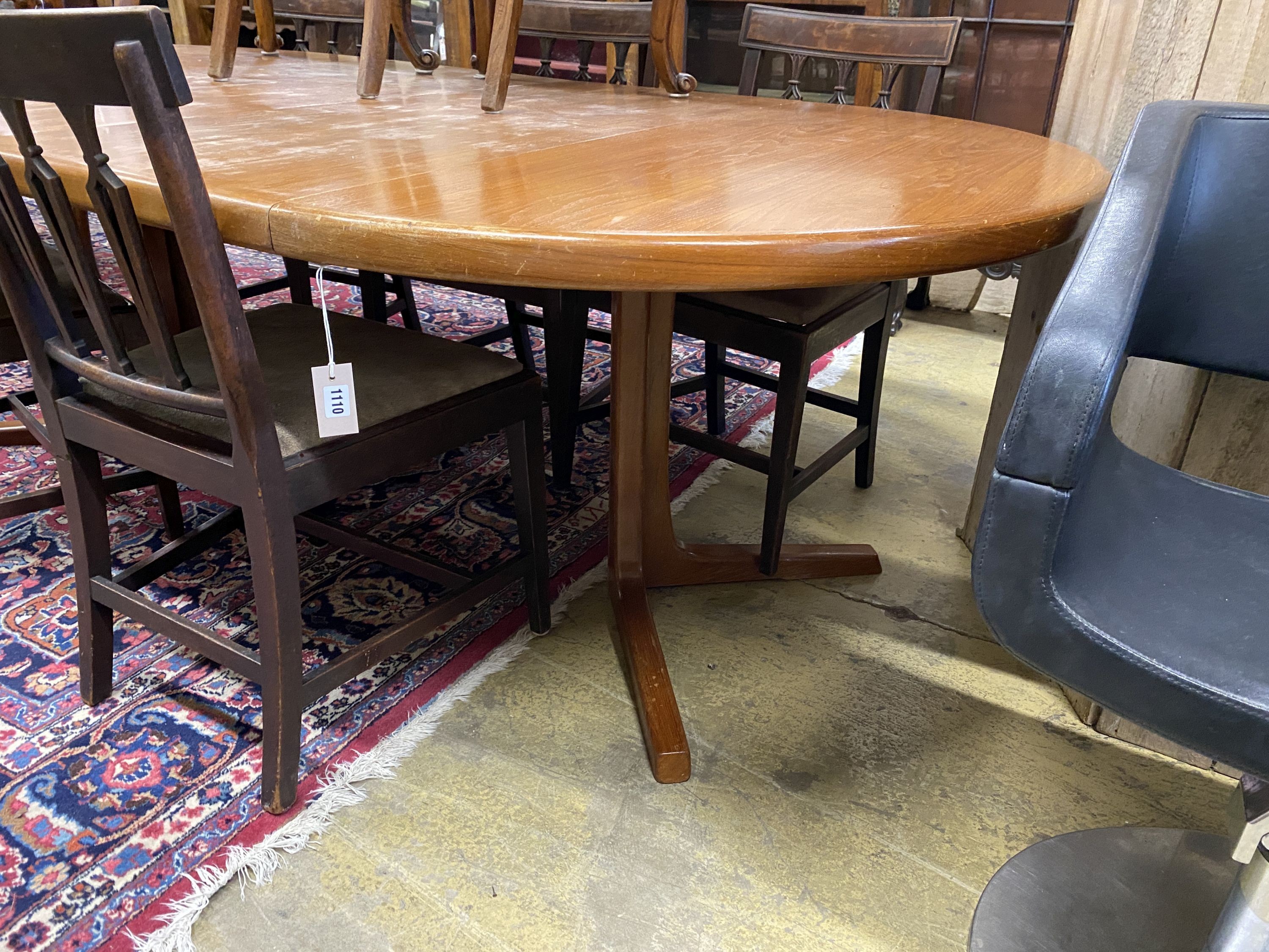 A mid century Danish teak circular extending dining table, two spare leaves, 220cm extended, width 120cm, height 72cm